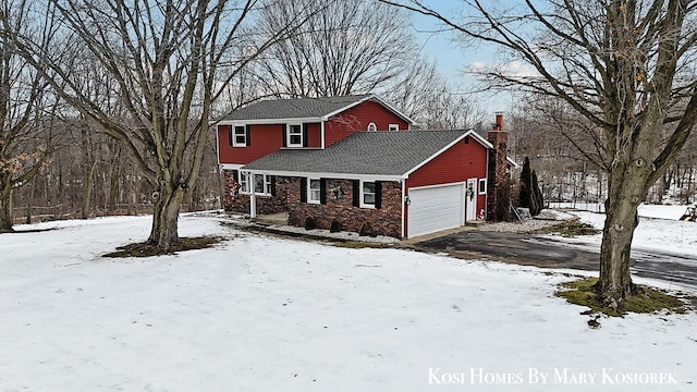 view of snowy exterior with a garage