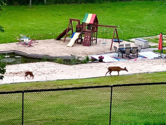 view of jungle gym with a lawn