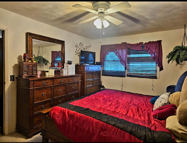 bedroom featuring ceiling fan and light carpet