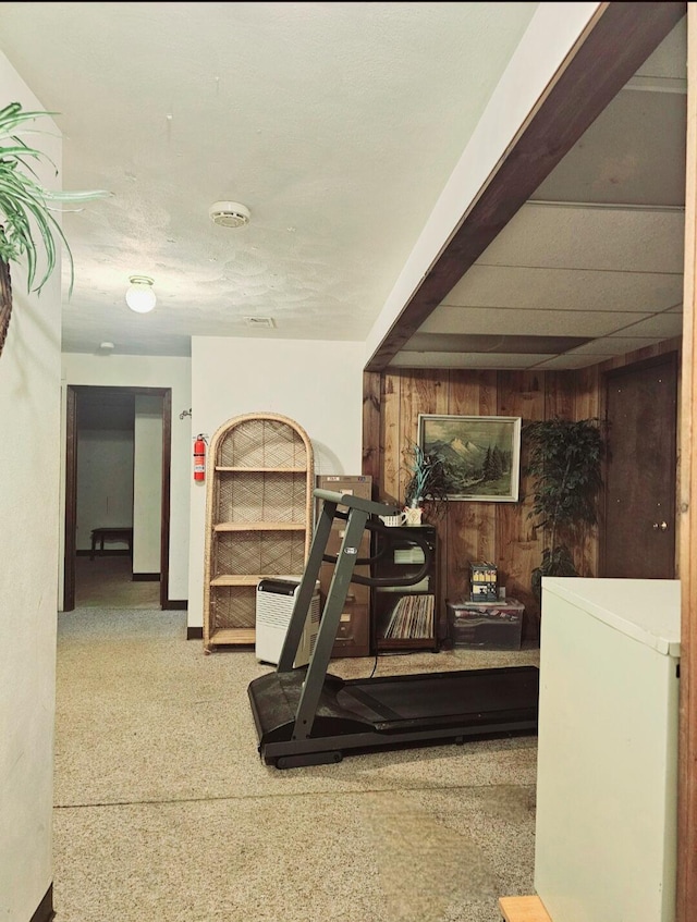 workout room featuring wooden walls