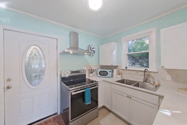 kitchen with white cabinetry, sink, wall chimney exhaust hood, crown molding, and electric stove