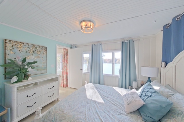 bedroom with a water view and light wood-type flooring