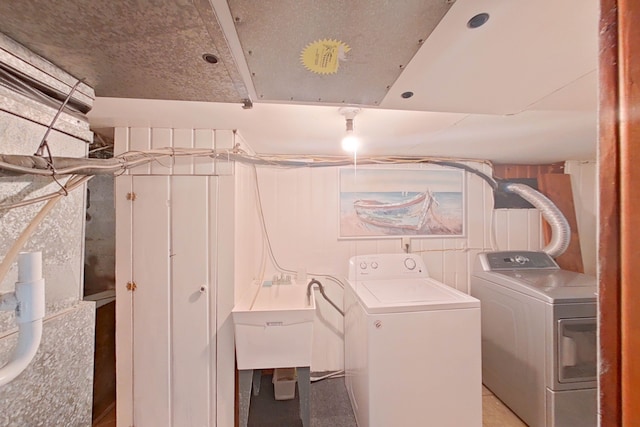 laundry room featuring sink and washer and clothes dryer