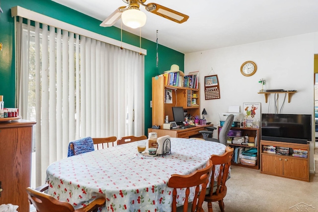 dining space featuring ceiling fan, light carpet, and a wealth of natural light