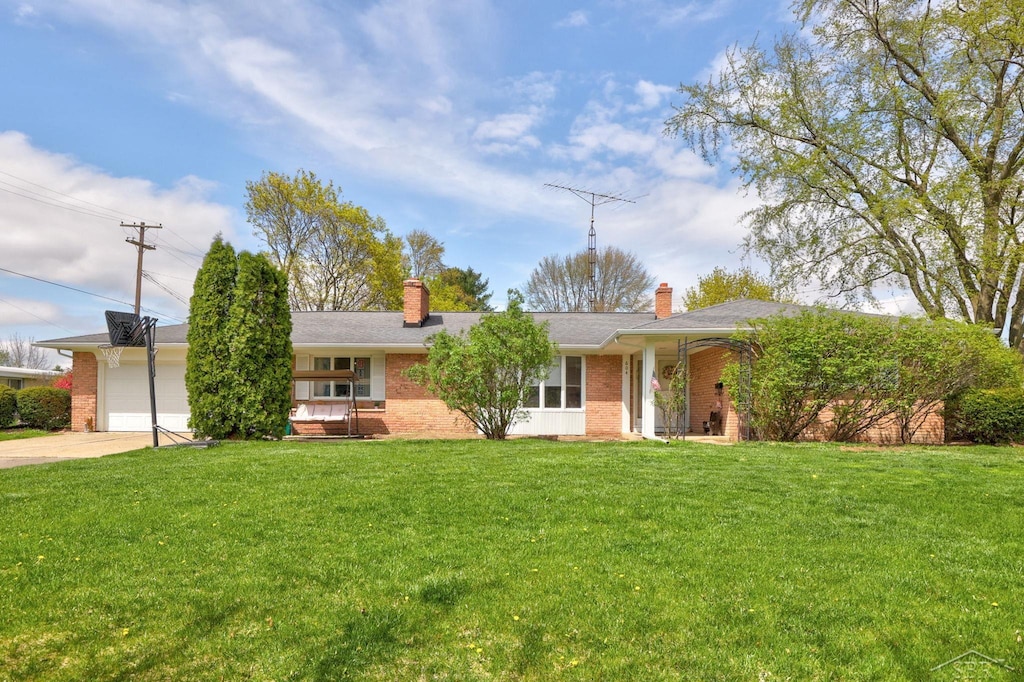 ranch-style house with concrete driveway, brick siding, and a chimney