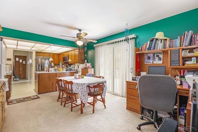 office area featuring light carpet and ceiling fan