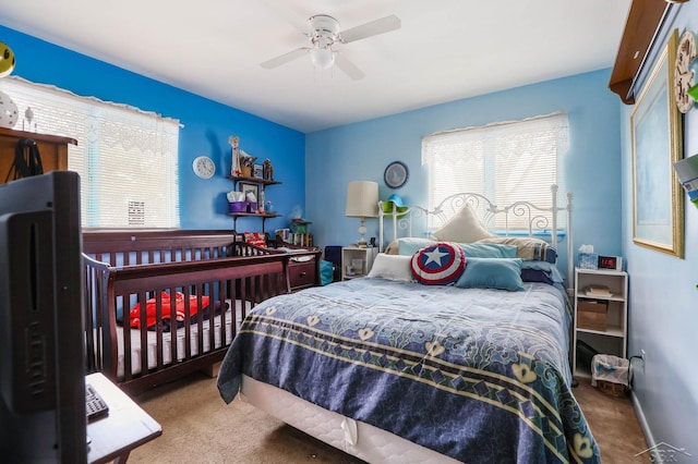 bedroom featuring ceiling fan and carpet