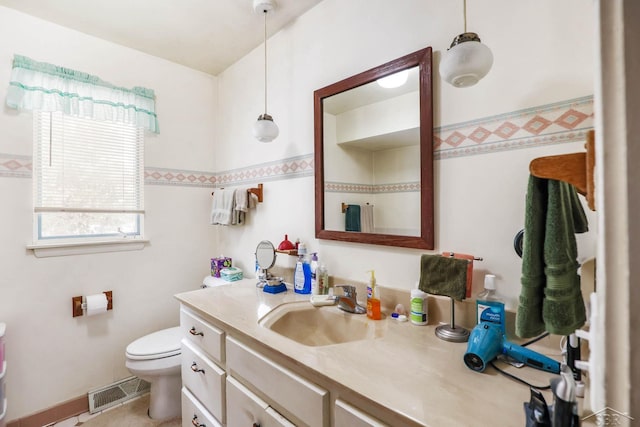 bathroom featuring vanity and toilet