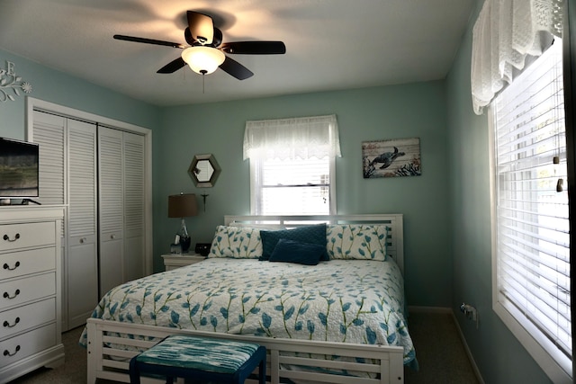 carpeted bedroom featuring ceiling fan and a closet