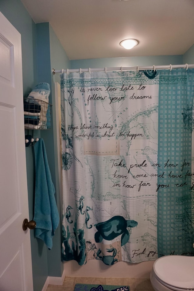 bathroom featuring curtained shower and toilet