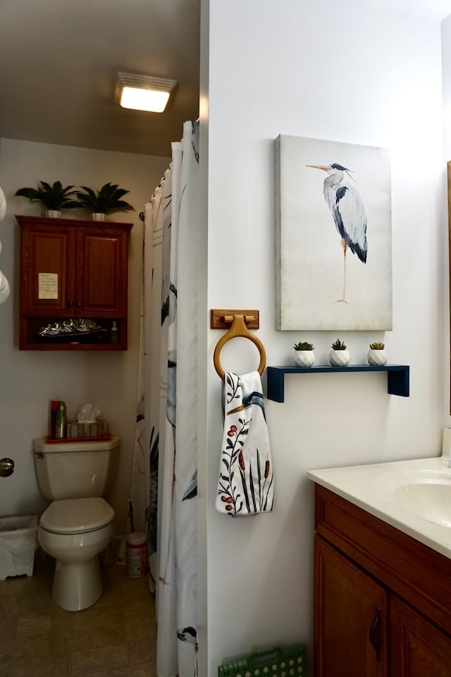 bathroom featuring vanity, tile patterned floors, toilet, and a shower with shower curtain