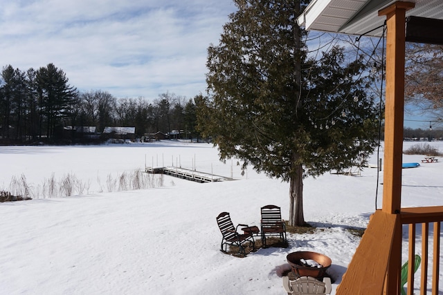 yard layered in snow with a boat dock