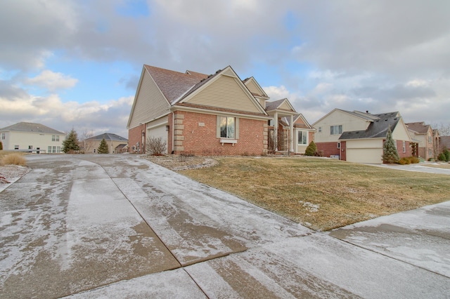 view of front of home with a garage and a front lawn