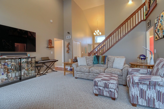 living room with an inviting chandelier, a towering ceiling, and carpet