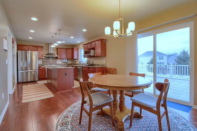 dining space with a notable chandelier and wood-type flooring