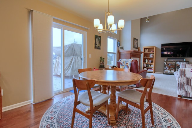 dining area featuring hardwood / wood-style floors and an inviting chandelier