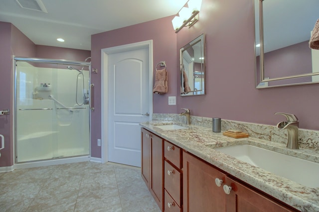 bathroom featuring walk in shower, vanity, and tile patterned flooring