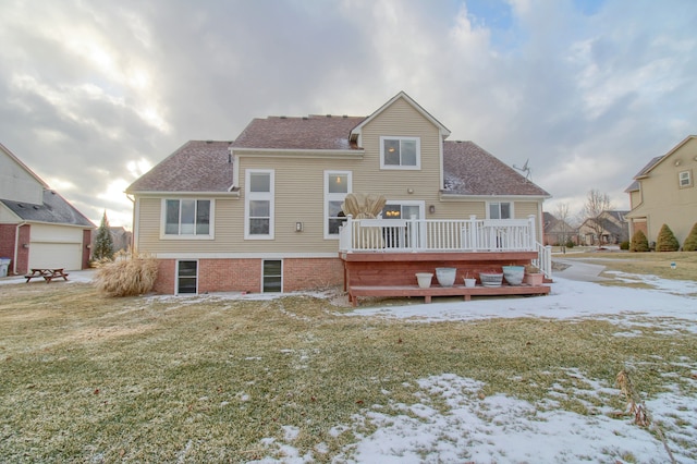 snow covered house with a wooden deck and a yard