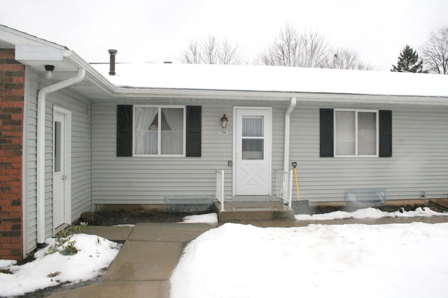 view of snow covered property entrance