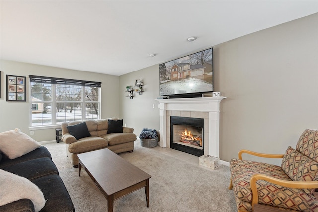 living room with light carpet and a tiled fireplace