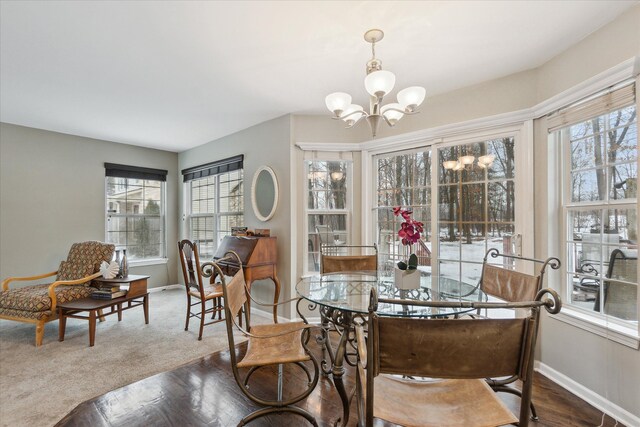 dining room featuring hardwood / wood-style flooring and a chandelier