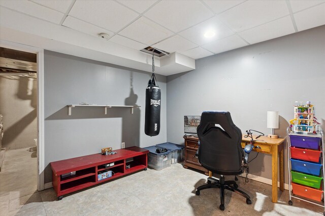 office space with a paneled ceiling