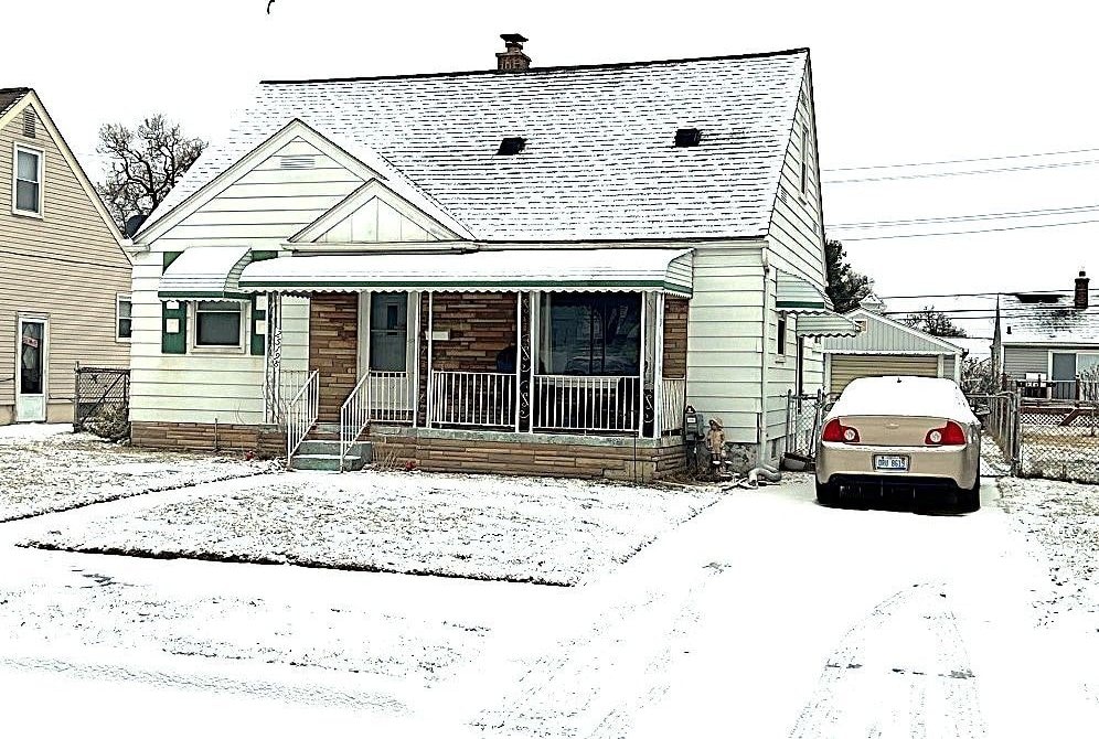 view of front facade with an outbuilding and a garage