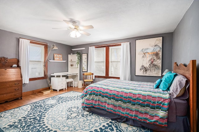 bedroom with ceiling fan and hardwood / wood-style floors