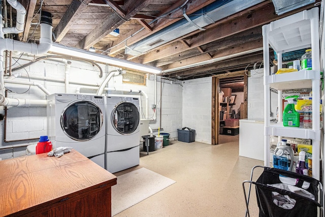 clothes washing area with washing machine and dryer