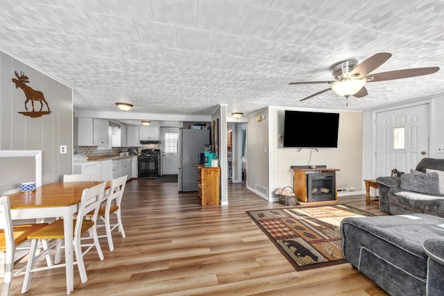 living room with ceiling fan and light hardwood / wood-style floors