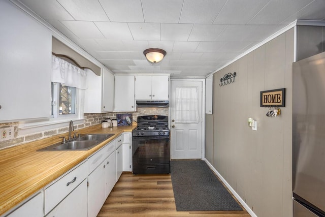 kitchen with sink, stainless steel refrigerator, black gas range, white cabinetry, and dark hardwood / wood-style floors