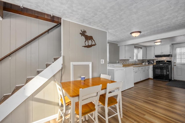 dining area featuring sink and dark hardwood / wood-style floors