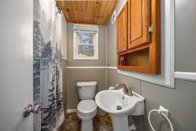 bathroom featuring sink, wooden ceiling, and toilet