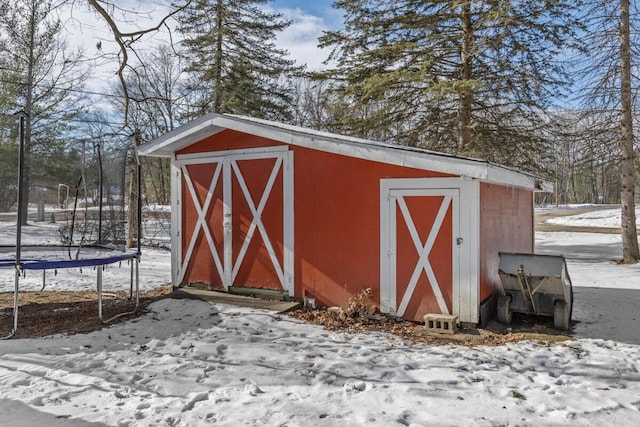 snow covered structure featuring a trampoline