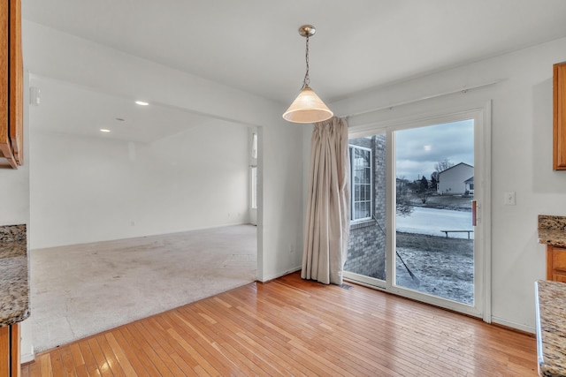 unfurnished dining area featuring light hardwood / wood-style flooring