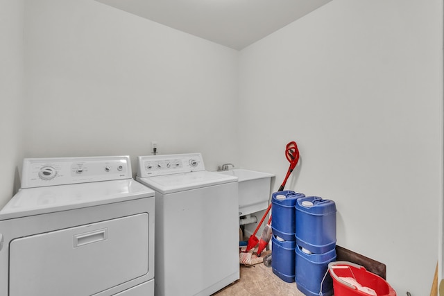 laundry room with washer and dryer and sink