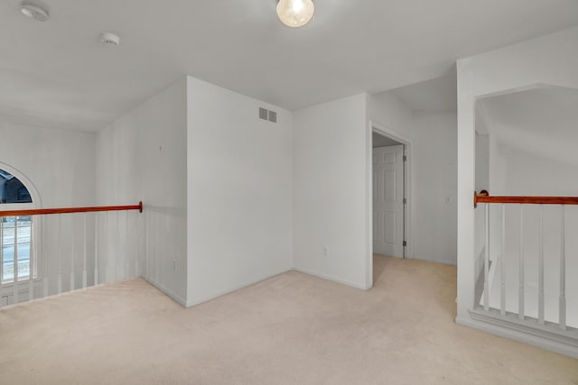 additional living space with light colored carpet