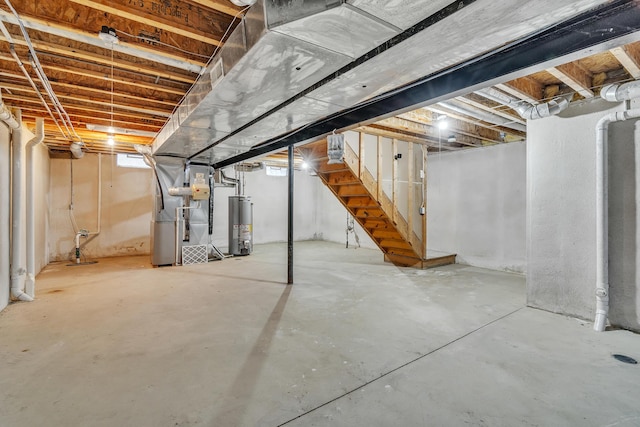 basement featuring heating unit and gas water heater