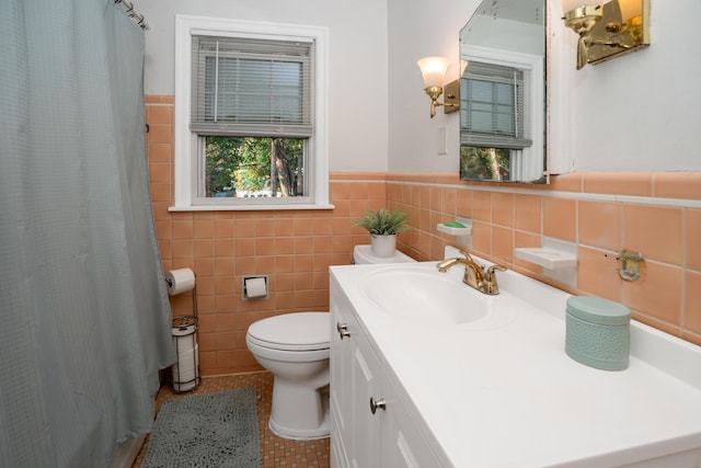 bathroom with tile patterned floors, toilet, tile walls, vanity, and a shower with shower curtain