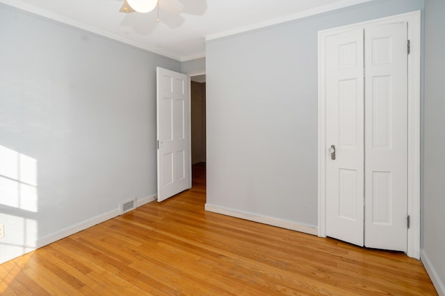 unfurnished bedroom featuring ornamental molding, ceiling fan, and light hardwood / wood-style floors