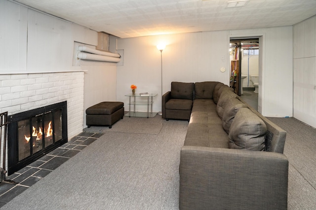 living room featuring a fireplace and dark carpet