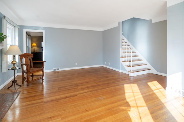 unfurnished room featuring wood-type flooring and crown molding