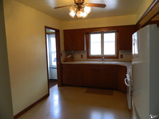 kitchen with ceiling fan, fridge, sink, and stove