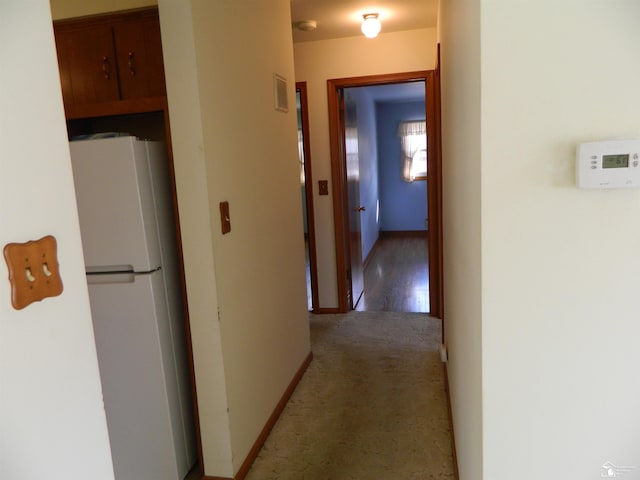 hallway with light colored carpet