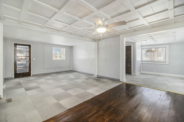 empty room featuring coffered ceiling and ceiling fan