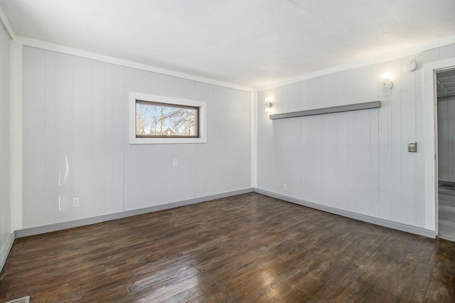 unfurnished room with dark wood-type flooring