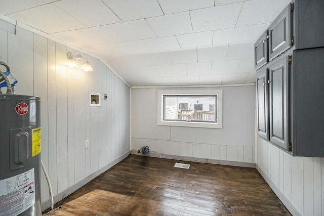 laundry room with hookup for a washing machine, electric water heater, and dark hardwood / wood-style floors