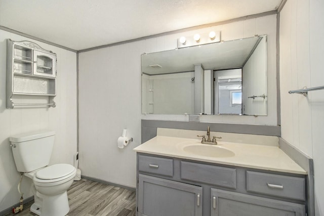 bathroom with hardwood / wood-style flooring, vanity, and toilet