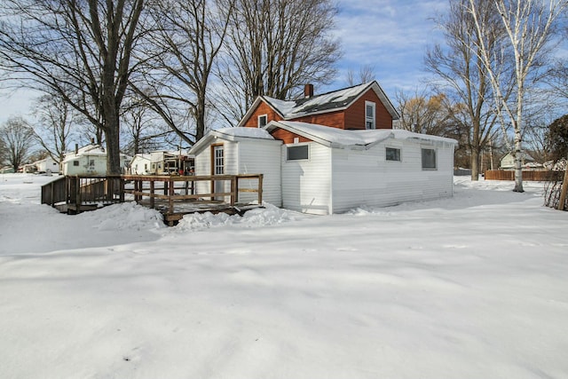 snow covered property featuring a wooden deck