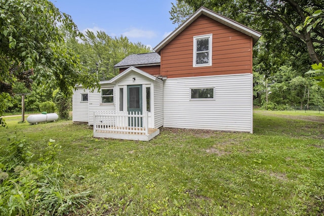239 Laurel St, Walkerville, MI 49459 - back of house with a shingled roof and a yard
